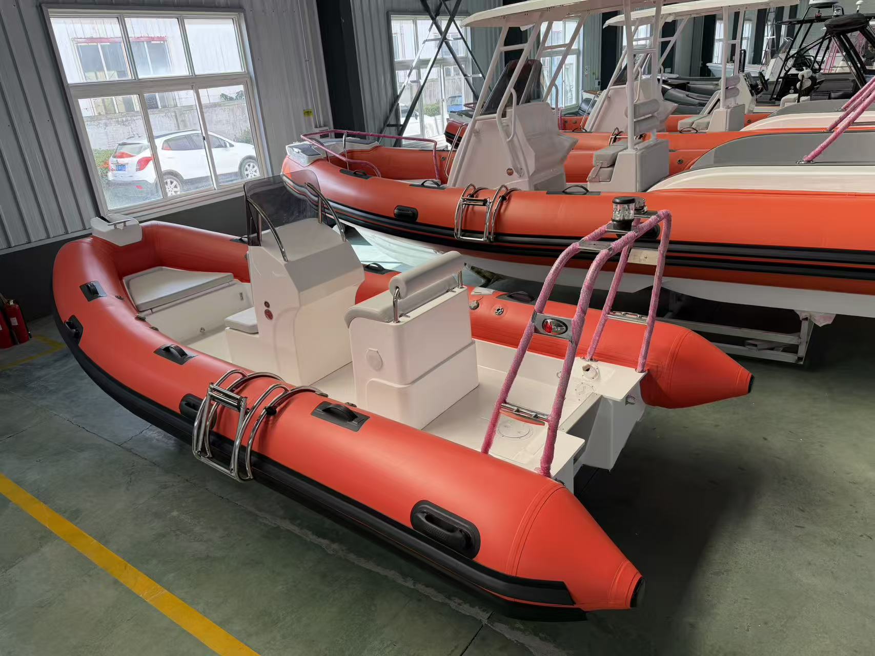 Spacious 17ft open deck fiberglass RIB boat for crew and gear movement.